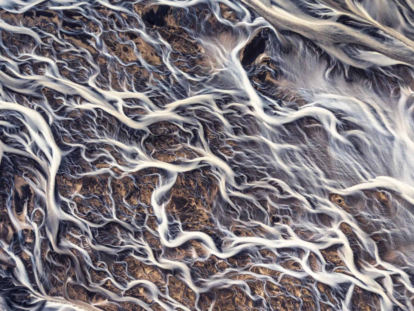 This aerial shot of a glacier river pattern was taken from a Cessna plane in the Southern part of Iceland