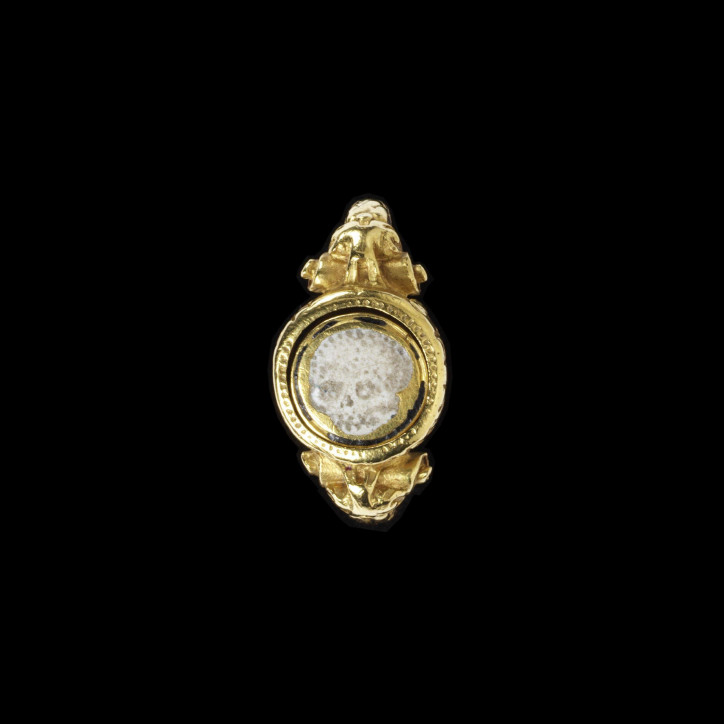 Żałobny pierścień z ok. 1600 r., wykonany ze złota, ozdobiony obrotowym elementem, na którego awersie znajduje się emaliowana na biało czaszka, na rewersie znak kupiecki, a na bocznej krawędzi widnieje napis: NOSSE TE IPSUM (Poznaj samego siebie); ©Victoria & Albert Museum, London
